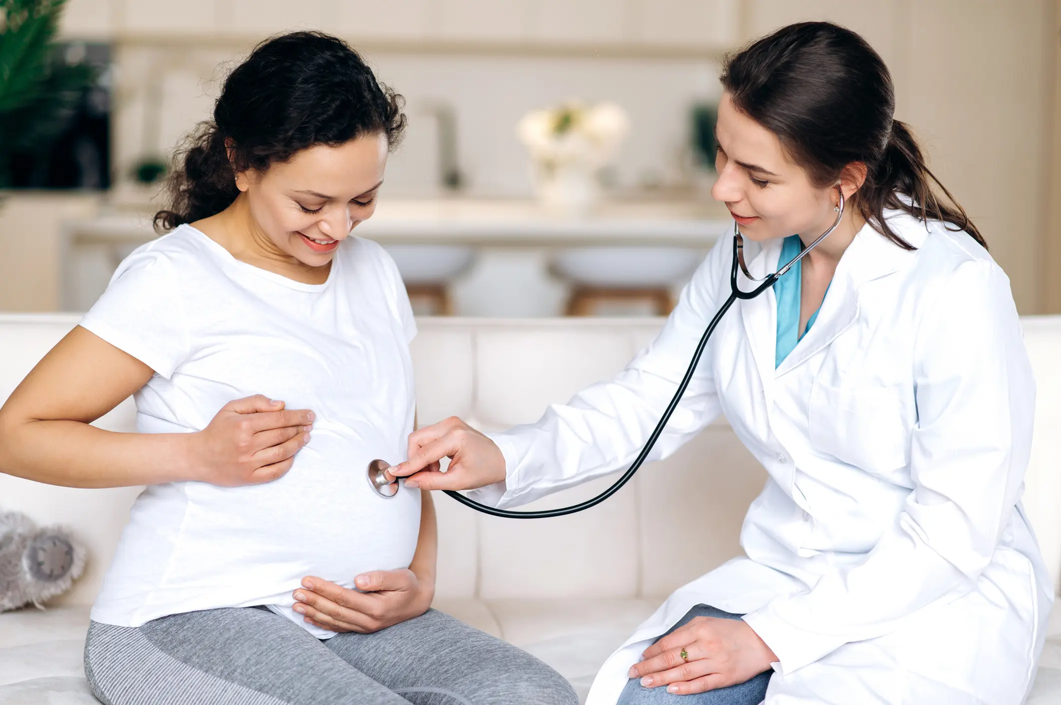 Doctor examining pregnant woman's belly